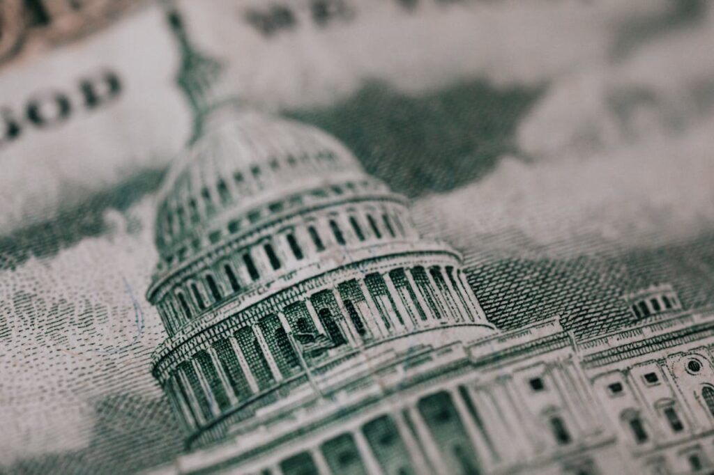 Close-up of the US Capitol illustration on American currency, showing detailed architectural design.