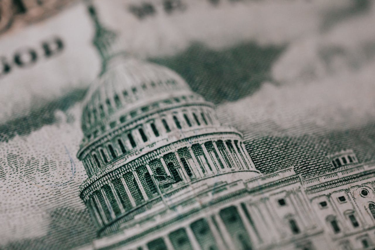 Close-up of the US Capitol illustration on American currency, showing detailed architectural design.